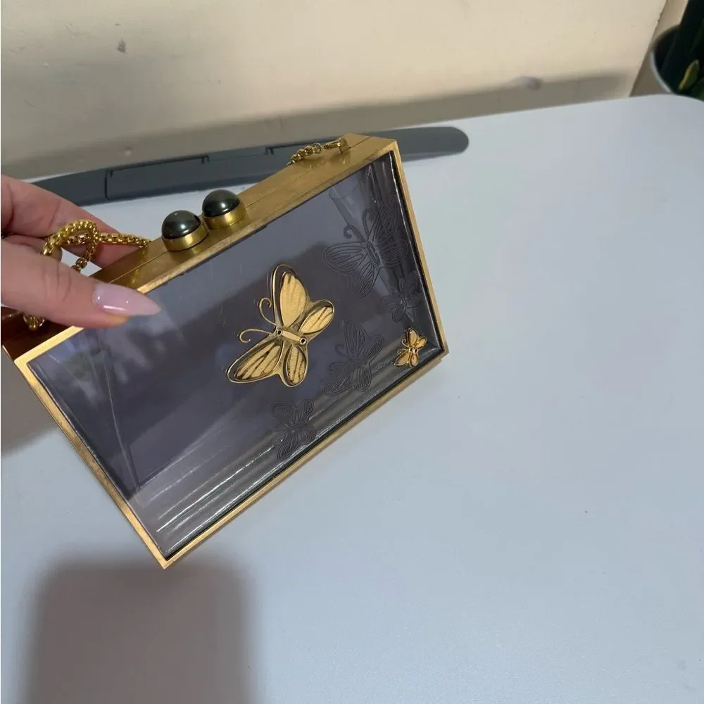 Thale Blanc - Flutter of Hope Clutch with a Gold Butterfly Design.